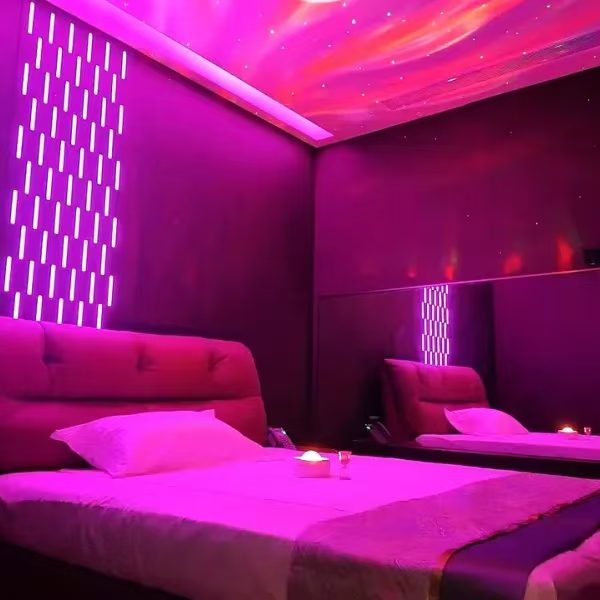 Guest room in pink-violet light.
